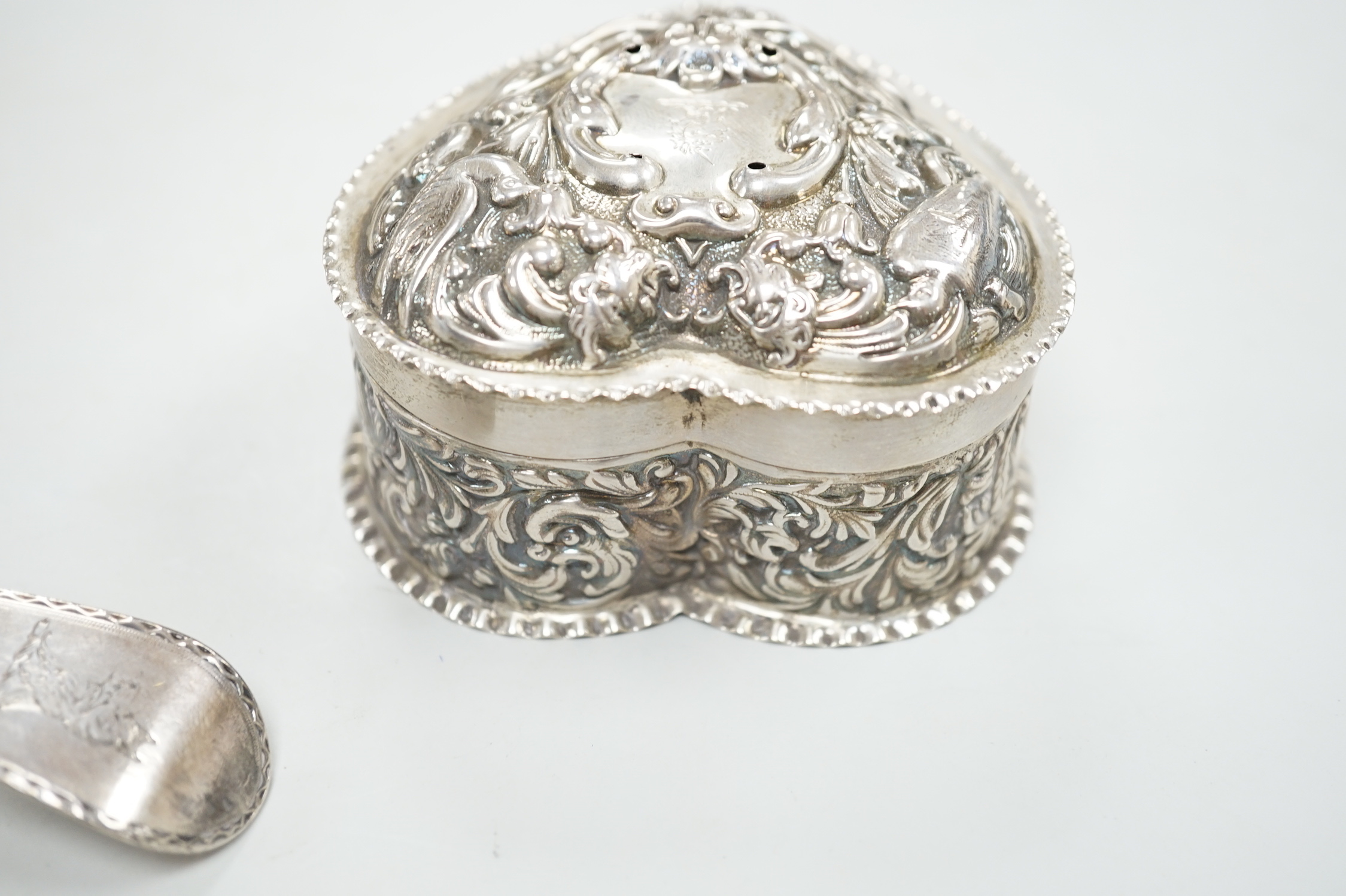 A George III silver Old English pattern bright cut engraved silver basting spoon, Sumner & Crossley, London, 1776 and a later repousse heart shaped trinket box.